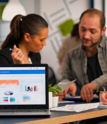 Business woman talking about financial project using laptop